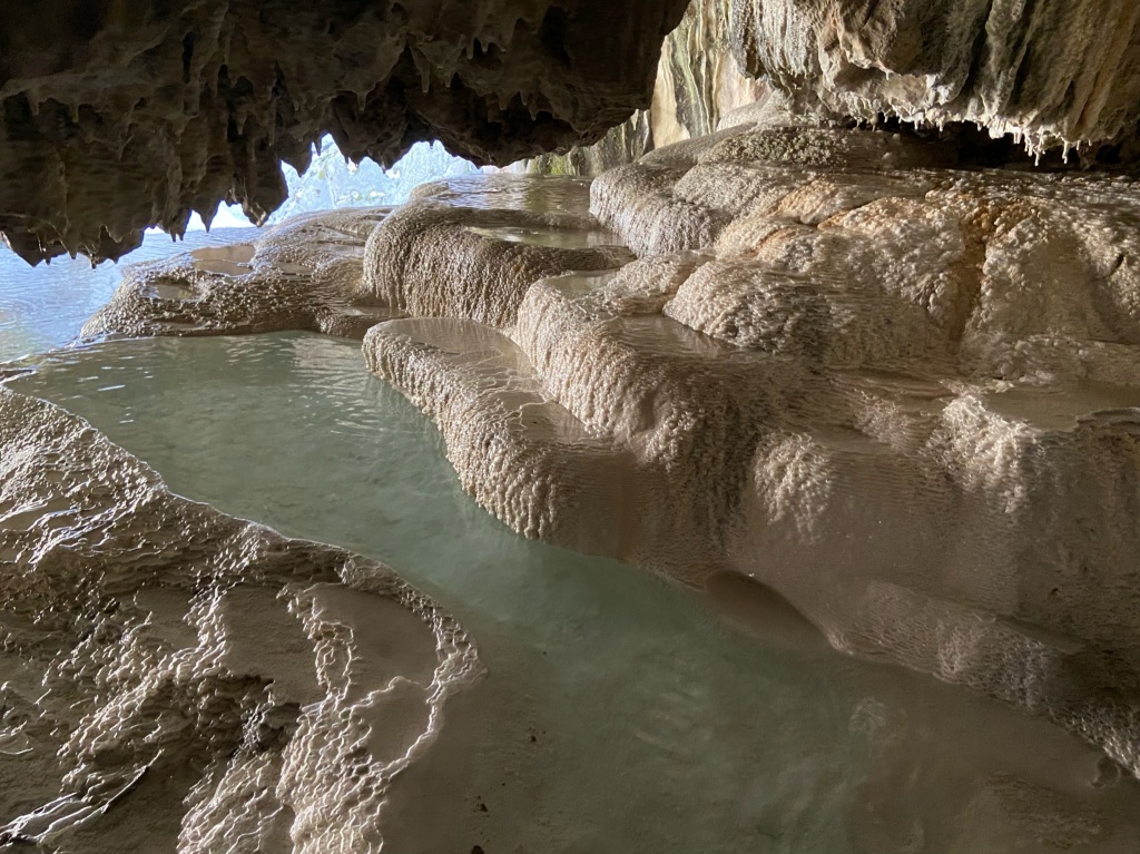 Interesting travertines pools formed by the deposition of minerals in the water. The ceiling is low and filled with tufa like formations.